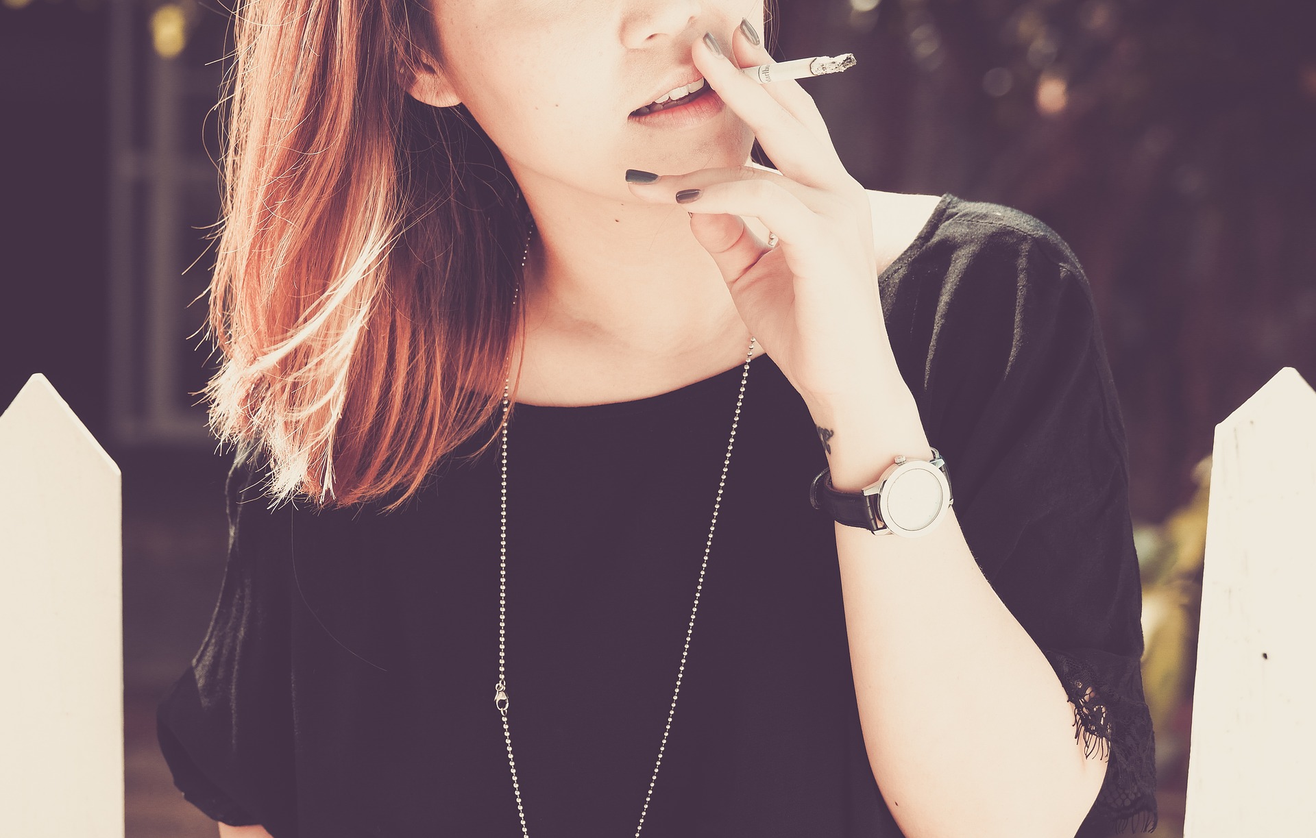 smoking and dental health -young woman smoking a cigarette