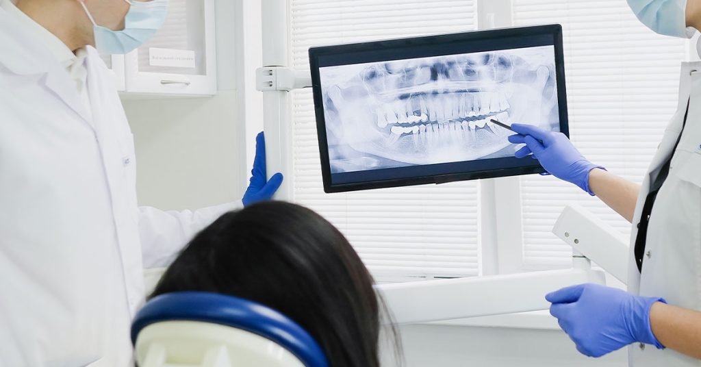 Dental xray examined by the dentists infront of patient